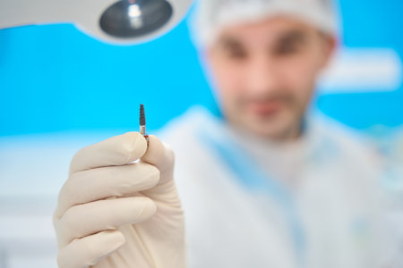 Doctor holds in his hand a dental pinの写真素材