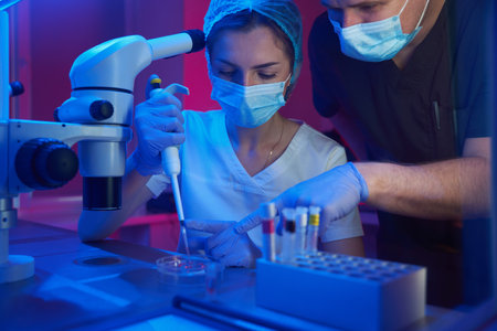 Young laboratory assistant of a modern cryo-laboratory works with biomaterial
