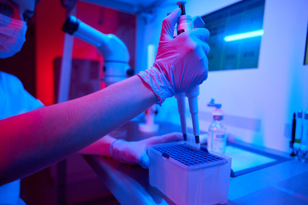 Female laboratory assistant in process of preparingbiomaterial for freezing