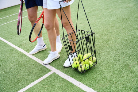 Tennis partners in sportswear walk along the tennis court
