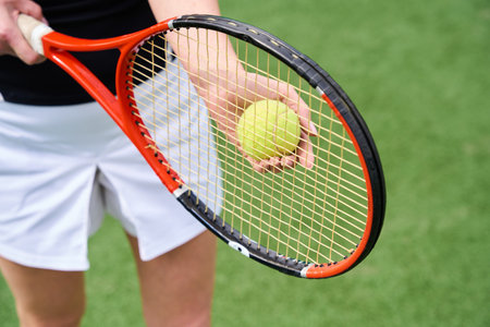 Young woman in sportswear on the tennis courtの写真素材