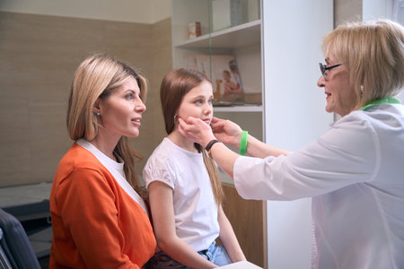 Doctor pediatrician examines a small patient at the receptionの写真素材