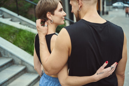 Young guys are hugging along the sidewalk in big cityの写真素材
