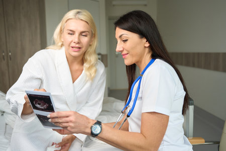 Two ladies are sitting in a hospital room