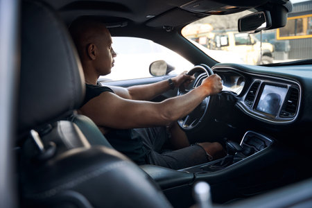 African American man driving on gas station to fill a full tankの写真素材