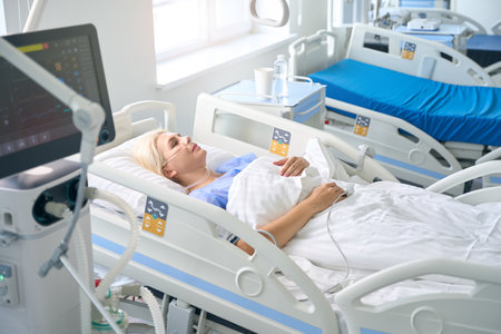 Middle-aged woman lies on a special hospital bedの写真素材