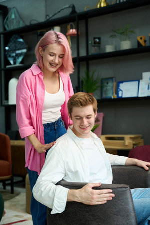 Young woman and man choose an armchair for their homeの写真素材