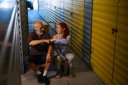 Smiling spouses sat down to rest on a cargo cartの写真素材