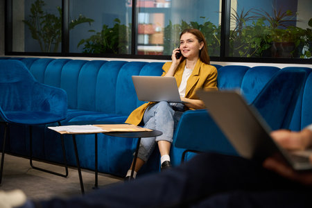 Young managers with laptops and mobile phones are located in coworking spaceの写真素材