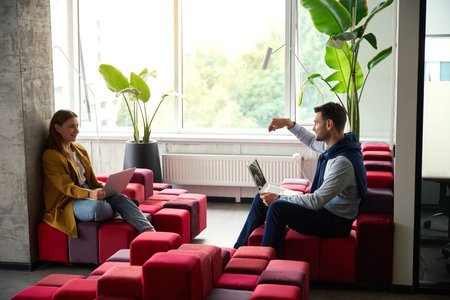 Freelancers, female and male, are located with laptops in coworking spaceの写真素材