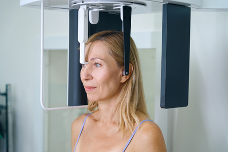 Mature female is undergoing digital cephalometry in dentistry clinic