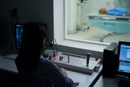 Experienced radiologic technologist is performing x-ray examination of patientの写真素材