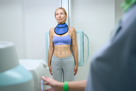 Adult female patient is being prepared for chest x-rayの写真素材