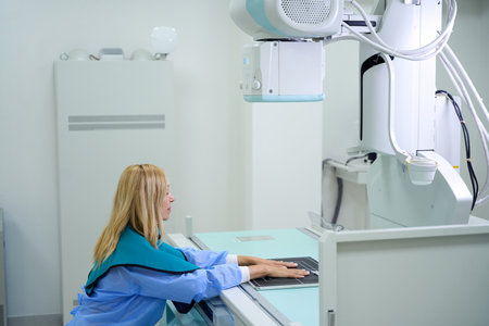 Adult woman undergoing diagnostic radiography of fingers and wristsの写真素材