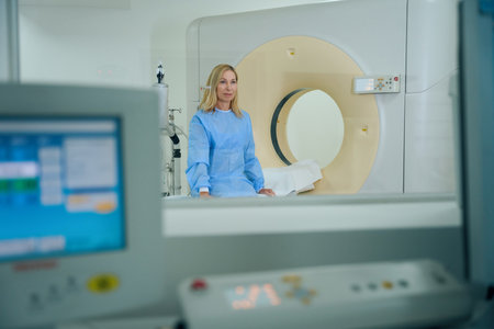 Calm female patient waiting for computed tomography procedureの写真素材