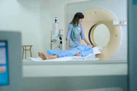 Qualified radiographer is getting patient ready for computed tomographyの写真素材