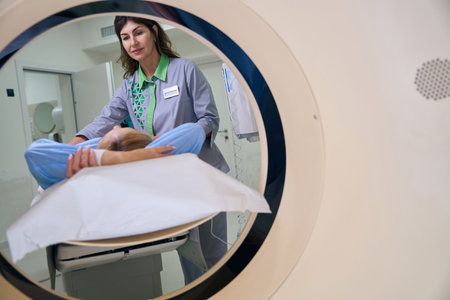 Radiologic technologist preparing adult patient for computed tomographyの写真素材