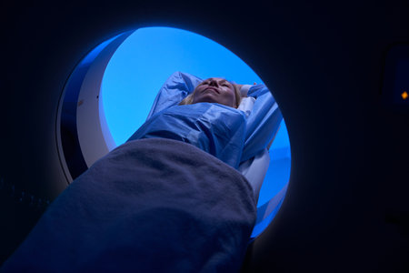Female client is undergoing computed tomography of abdomenの写真素材