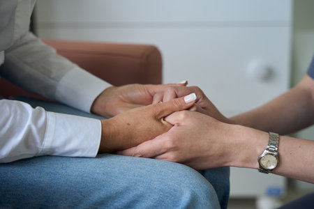 Caring general practitioner giving comfort to patientの写真素材