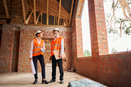 Joyous building inspector communicating with contractor during site inspection