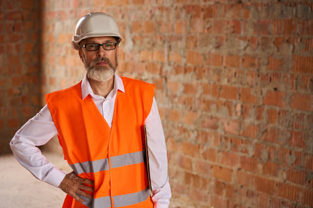 Construction superintendent posing for camera before building site inspectionの写真素材