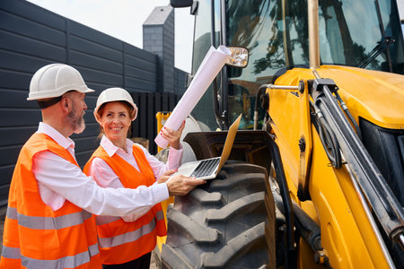 Two construction specialists inspecting together building site