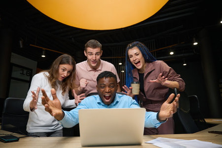 Extremely happy satisfied people looking at laptop display