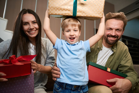 Surprised little boy rejoicing his gifts during New Year celebratingの写真素材