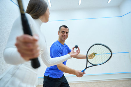 Woman player and man coach participate in competition showcasing learned skillsの写真素材