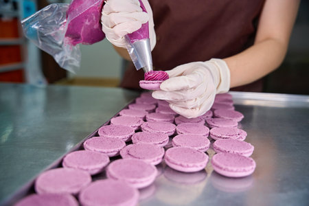 Pastry chef is making biscuits on kitchen countertopの写真素材