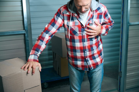Bald man in shirt has heartache when movingの写真素材