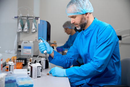 Male laboratory assistant examines biological material in a modern laboratory