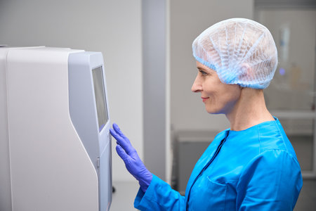 Female laboratory assistant works in a laboratory on modern equipmentの写真素材