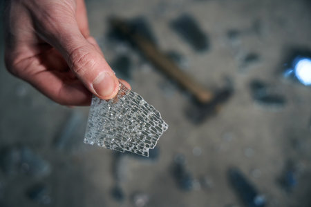 Worker holds a piece of triplex glass in his hands