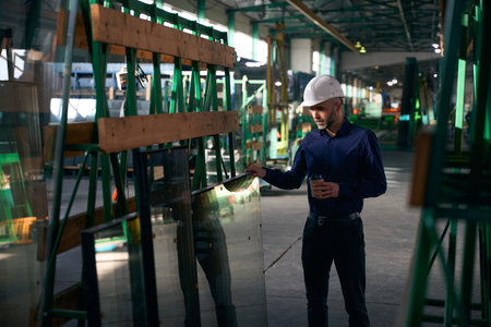 Man on a coffee break in a production workshopの写真素材