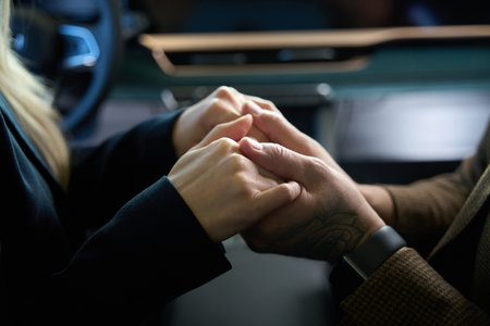 Male hands holding female hands in front of the cameraの写真素材