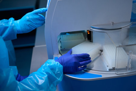Specialists work on machine for automatic extraction of nucleic acids