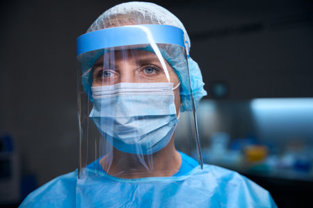 Woman in a modern laboratory in protective equipmentの写真素材