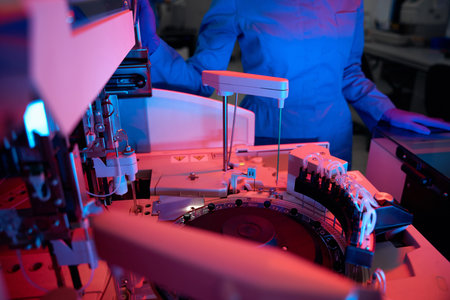 Laboratory employee uses machine for automatic isolation of nucleic acids