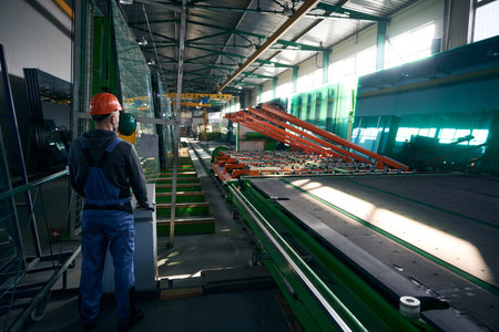 Worker uses modern equipment to work with glassの写真素材
