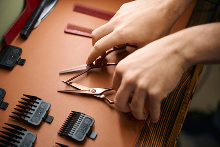Professional hair cutting scissors in unrecognizable hairdresser handsの写真素材