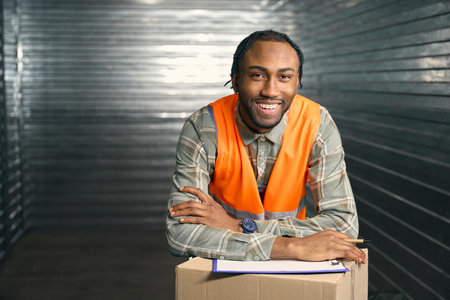 Cheerful employee posing for camera in storage unit