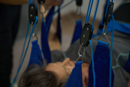 Fitness clinic employee placed the patient on a harnessの写真素材