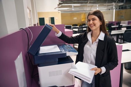 Caucasian woman making a copy of documents in the office