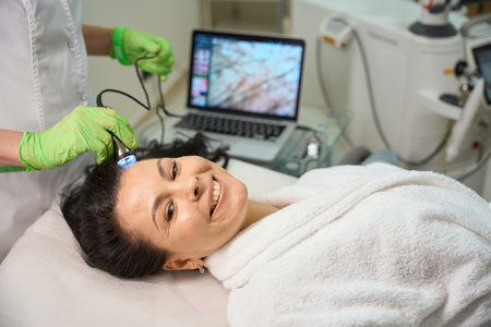 Patients hair is checked using a trichoscope