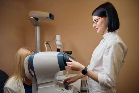 Young ophthalmologist uses special equipment in her work
