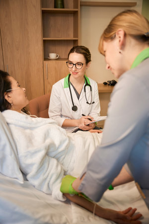 Nurse puts an IV on a patientの写真素材