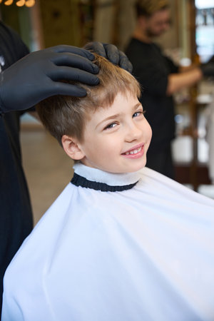 Little client is satisfied with new hairstyleの写真素材