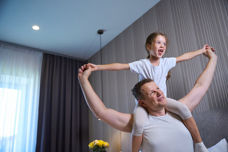 Dad and his little daughter are having fun morning get upの写真素材