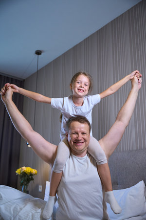 Little girl and her dad are having fun morning get upの写真素材